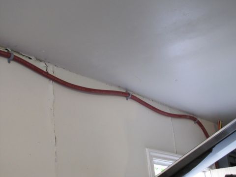 1993 Ford F-250 - Red conduit runs along the ceiling and wall, secured with zip ties.
