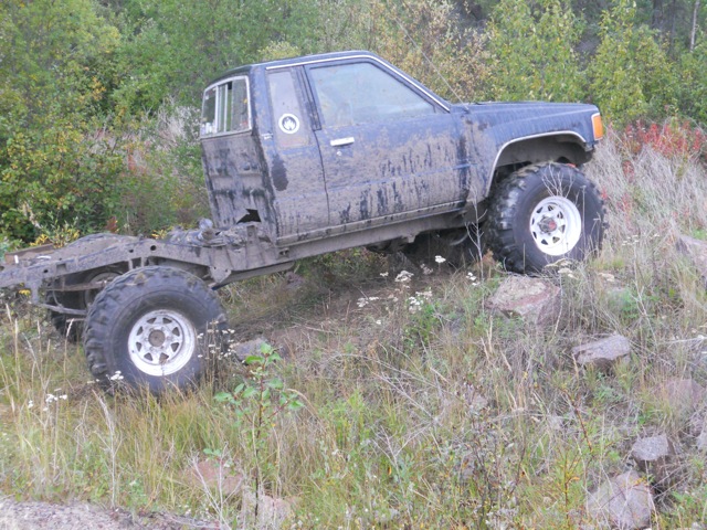 Black pickup truck chassis with cab, side view, lifted suspension