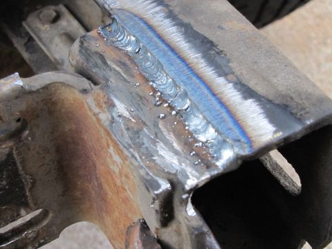 1993 Ford F-250 - Newly welded metal frame part shows signs of recent repair work.