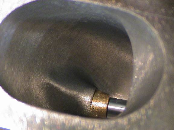 Carbide burr porting the inside of a cylinder head intake port