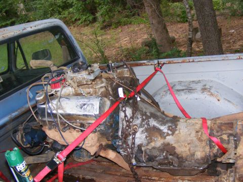 1978 Ford Bronco - Engine and transmission assembly being transported in the bed of a pickup truck.