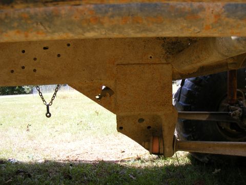1978 Ford Bronco - The heavily rusted frame and suspension components of an off-road vehicle are shown in this close-up shot.