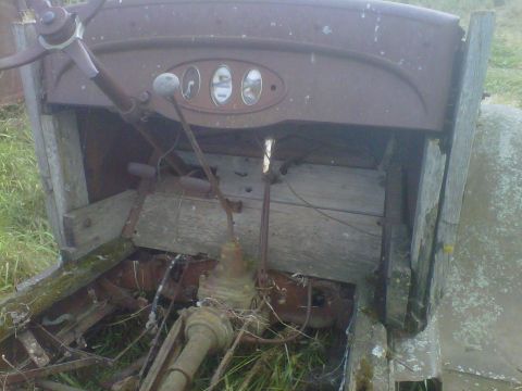 1978 Chevrolet C/K Pickup - The interior of a weathered and rusty truck shows a steering wheel, three gauges, and a manual transmission shifter.