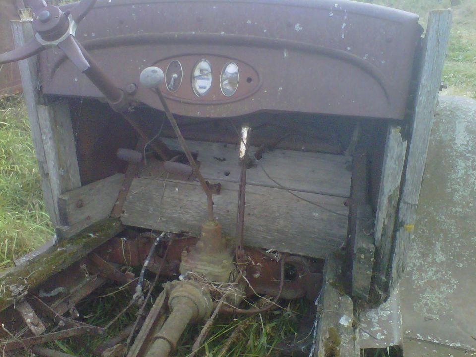 Rusty truck interior with three gauges and a steering wheel