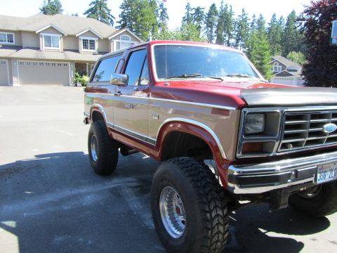 1984 Ford Bronco - This lifted Ford Bronco features a two-tone paint scheme and aggressive off-road tires.