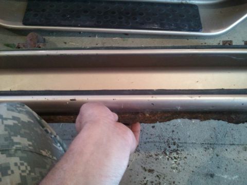 1996 Ford Bronco - The door sill and floor of a 1996 Ford Bronco show signs of use and age.