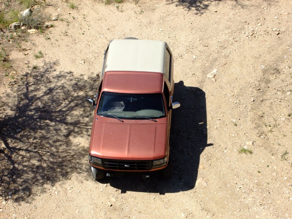 1995 Ford Bronco parked on dirt, viewed from above