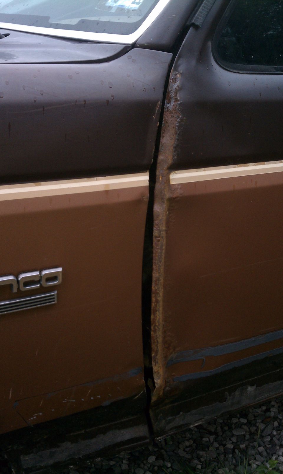 Original drivers side door has crimp and rust.