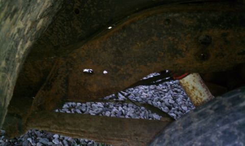 1990 Ford Bronco - Rear drivers side frame, original paint is still visible.
