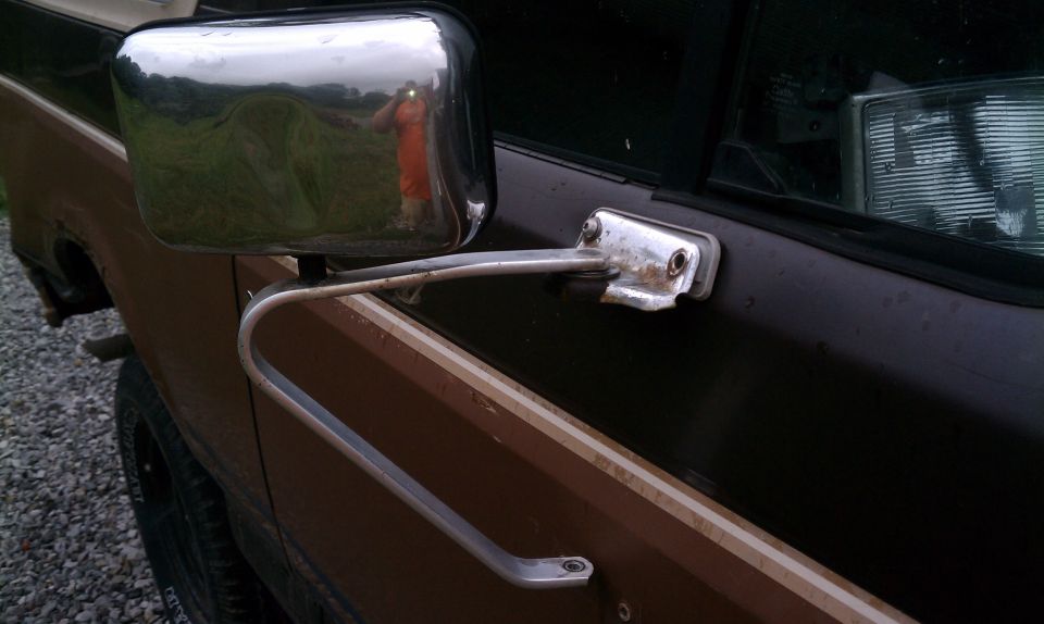 Passenger side mirror missing bolts.