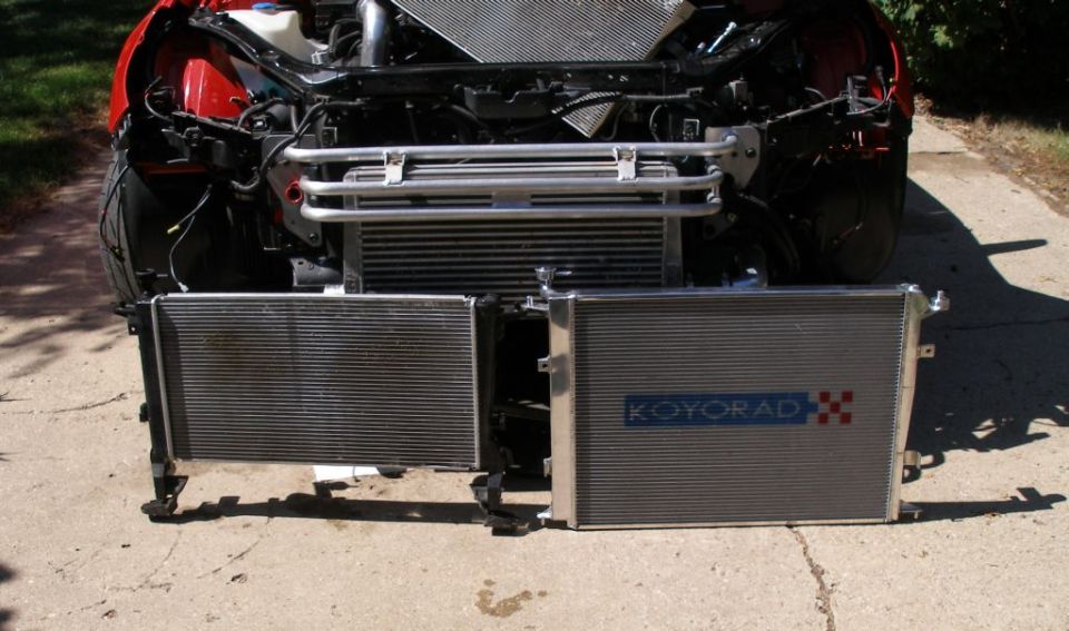Two radiators removed from car front end; one has KoyoRad logo