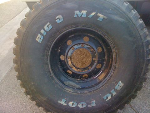 1987 Suzuki Samurai - Close-up of a Bigfoot M/T tire, suggesting off-road capability.