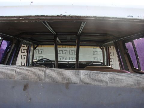 1979 Ford Bronco - The interior of a vehicle shows a custom roll cage structure, with the steering wheel and dashboard in view.