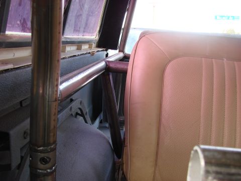 1979 Ford Bronco - Close-up view of the interior, focusing on the roll cage and a tan seat.