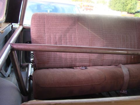 1979 Ford Bronco - The interior of a 1979 Ford Bronco shows a custom roll cage installed behind the rear seat.