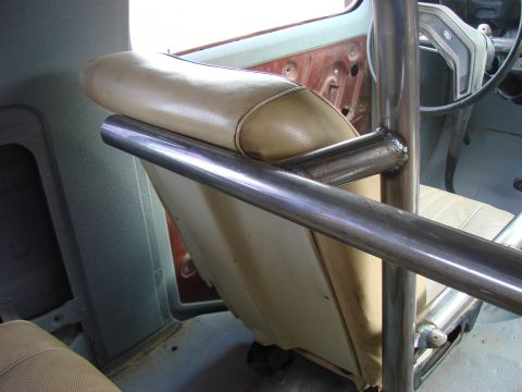 1979 Ford Bronco - Interior view of a vehicle's roll cage and seats, with a partial view of the steering wheel and dashboard.