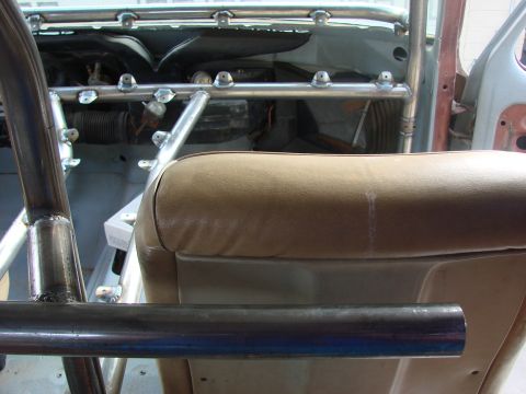 1979 Ford Bronco - Custom roll cage installed in the interior of a vehicle, with a tan seat visible.