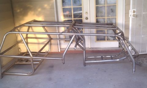 1979 Ford Bronco - A custom metal roll cage frame is shown, likely for an off-road vehicle, with a doorway in the background.