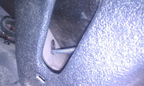 1979 Ford Bronco - Parking brake cable assembly with a coiled spring and bracket.