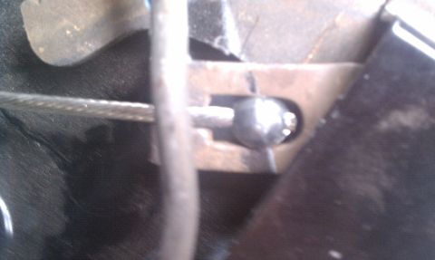 1979 Ford Bronco - Detail of a parking brake cable mechanism, showing the connection point.