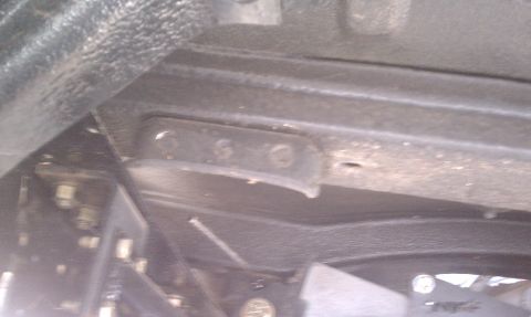1979 Ford Bronco - Close-up of vehicle undercarriage showing frame and suspension mounting points.