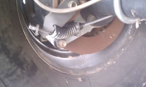 1979 Ford Bronco - Parking brake assembly detail, showing the cable and spring mechanism.