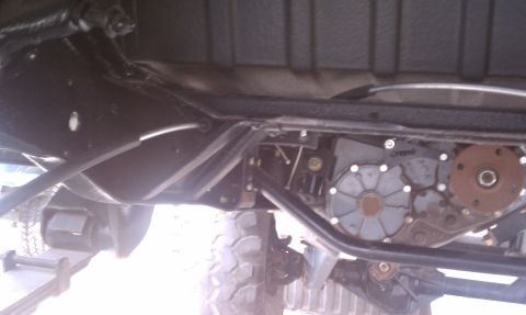 1979 Ford Bronco - Close-up of the vehicle's undercarriage, focusing on the transfer case and related mechanical parts.