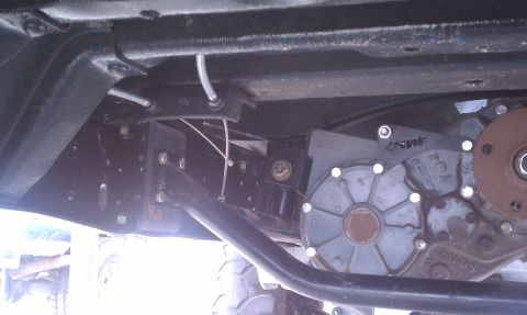 1979 Ford Bronco - This image shows the underside of a vehicle, focusing on the transfer case and associated mechanical parts.