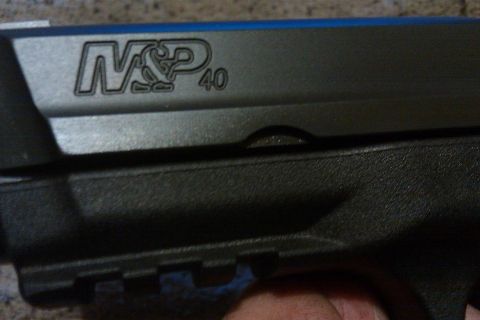 2000 Mercury Grand Marquis - The slide of an M&P 40 pistol is visible, with blue accents along the top edge.