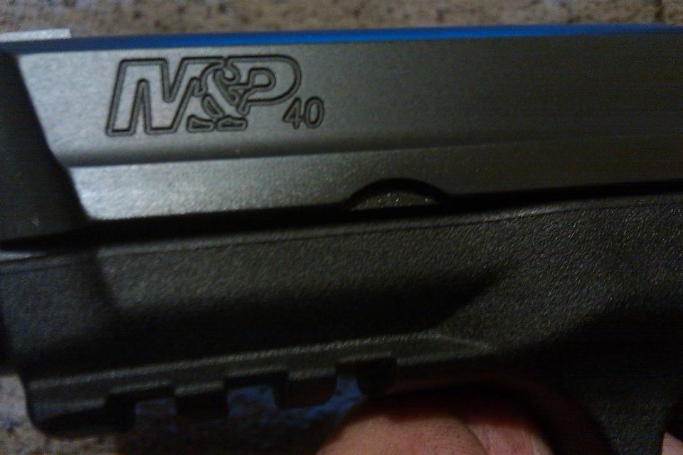Close-up of M&P 40 pistol slide with blue accents