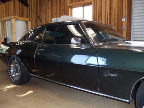 1969 Chevrolet Camaro - Side view of a 1969 Chevrolet Camaro coupe with chrome trim and period-correct wheels.
