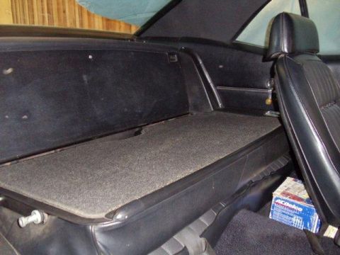 1969 Chevrolet Camaro - The interior of a car shows the rear seat and trunk area, with a box of ACDelco parts visible.
