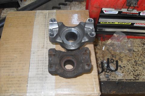 1997 Ford Ranger - Comparing a new driveshaft yoke to an old, rusted one. Hardware is also visible.