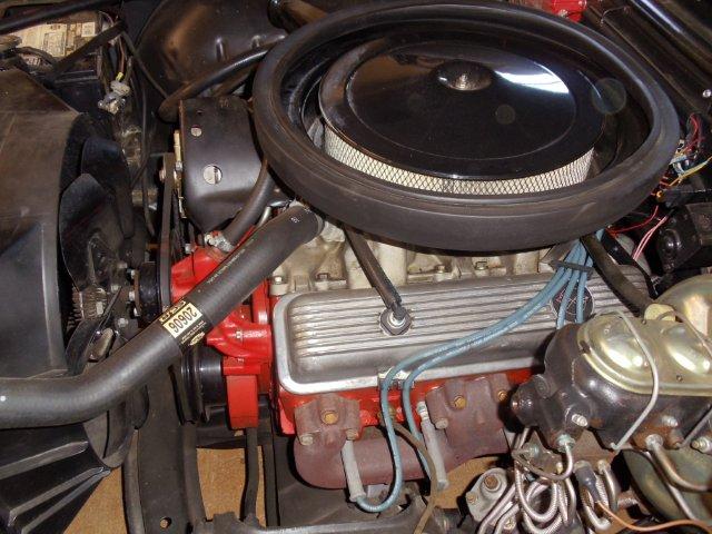 engine bay with air cleaner, fan, and brake master cylinder visible
