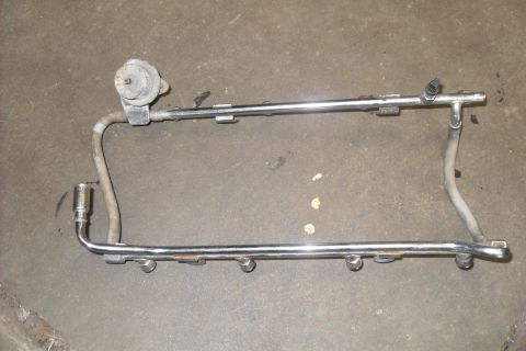 1997 Ford Ranger - Fuel rail assembly with pressure regulator and fuel line connections, likely for an older vehicle.