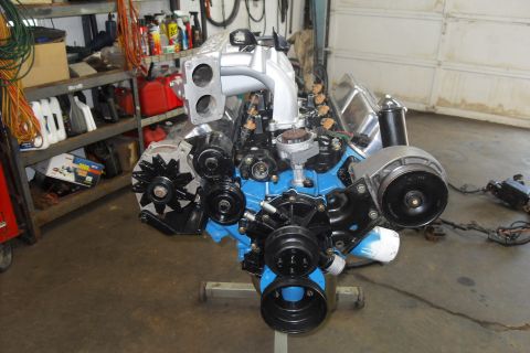 1997 Ford Ranger - Engine assembly on a stand, a blue block and silver intake manifold, with various pulleys and belts visible.
