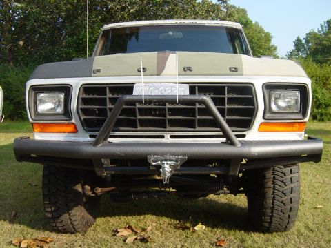 1979 Ford Bronco - This Ford truck features a heavy-duty bumper and a camouflage pattern on its hood.