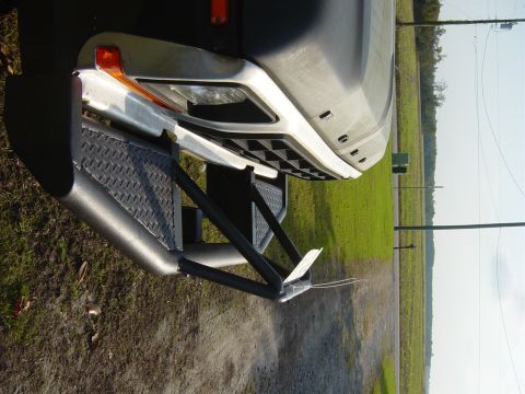 1979 Ford Bronco - The distinctive grille and custom front bumper of a 1979 Ford Bronco are visible in this close-up shot.