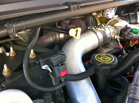 2004 Ford F-250 - Close-up view of an engine bay, highlighting the turbocharger and associated plumbing, with an 'ENGINE OIL' cap visible.