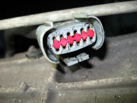 1992 Ford Bronco - Electrical connector with a pink insert and pins, likely part of a vehicle's wiring harness.
