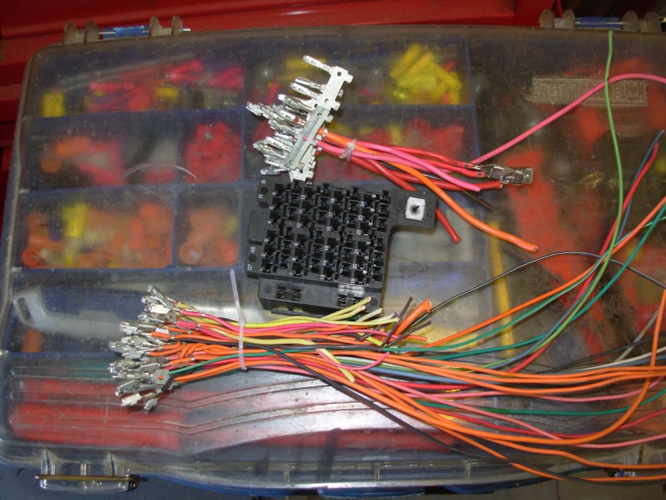 Among other electrical mods, I'd like to have an in-dash USB power socket.  So I'm adding a fuse to the stock dash fuse box by installing a pigtail terminal from a junkyard fuse block.  I've stripped all the terminals from this one, including the buss bars (above).  To add a fuse to a position with no buss bar terminal, simply solder or crimp a pigtail into an empty position on the back of a buss bar with the electrical chracterstics needed (battery, key-switched, etc.).  Remember that the current flowing out of the fuse has to flow in, so the battery-side wire must be the same size or larger than the load wire.

SEE THE NEXT PIC...