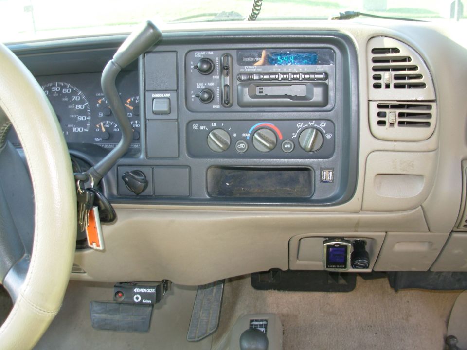Tan dashboard radio and HVAC control center of a 1990s truck