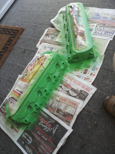 1989 Ford Bronco - Engine components are being spray-painted green and laid out on newspapers.