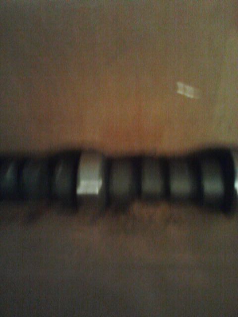 1989 Ford Bronco - A camshaft is visible, several lobes that operate the engine's valves.