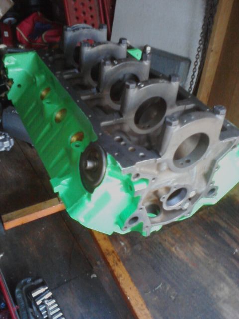 1989 Ford Bronco - A green engine block with bearing caps is shown, likely for a vehicle rebuild or restoration project.