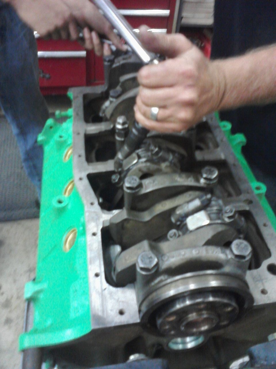 Engine block with crankshaft being worked on, green painted side panel