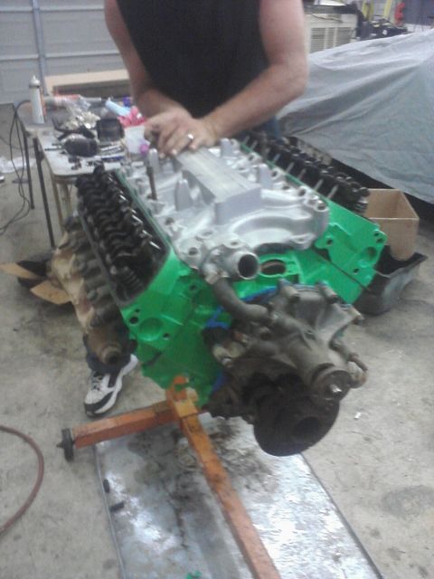 1989 Ford Bronco - Engine block painted green and mounted on an engine stand for maintenance.