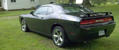 2011 Dodge Challenger - This Dodge Challenger is parked on a grassy lawn next to a white house.