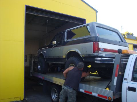 1989 Ford Bronco - 1989 Ford Bronco being loaded onto a tow truck.