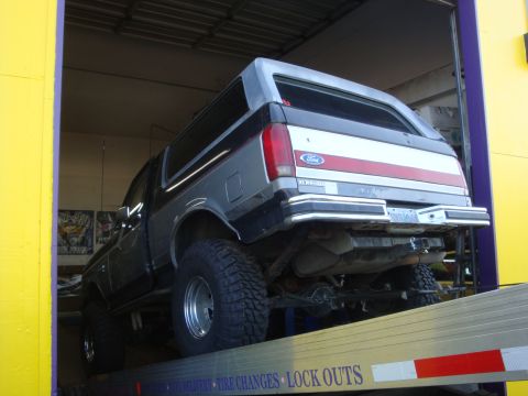 1989 Ford Bronco - The rear of a 1989 Ford Bronco is visible as it is loaded onto a trailer.